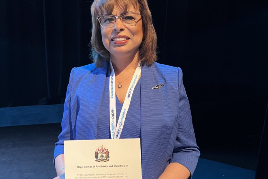 Doctor Nashwa Matta stands with her award after presentation at conference in Liverpool