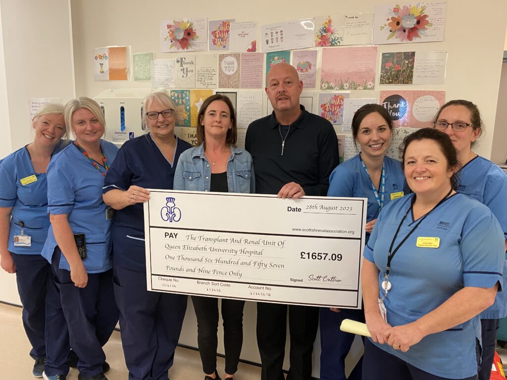 Scott Cather and wife Diane hand over their donation to the team at Ward 4C