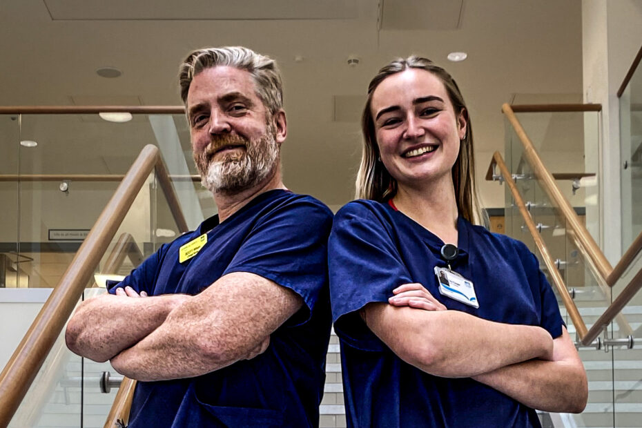 Nurses Scott Wilson and Clio Cooter stand smiling side by side after winning a major prize for the presentation on patient experience.