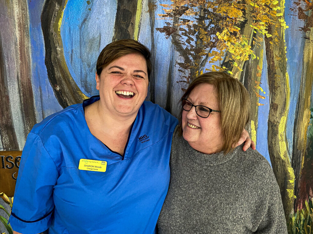 Charge Nurse Sharon Woods and Health Care Support Worker Caroline Swan smiling and laughing in Ward 56 at the QEUH