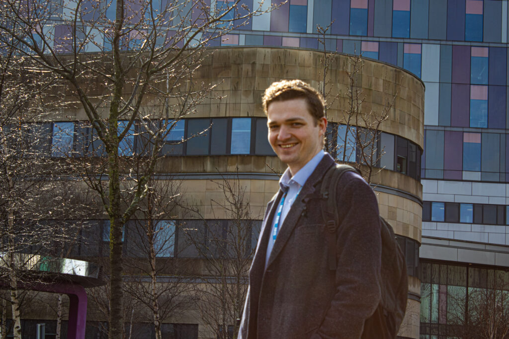 Smiling George Bruce standing outside the Queen Elizabeth University Hospital.