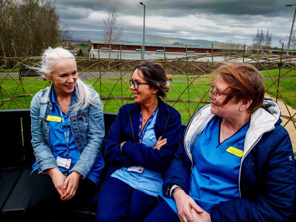 Enjoying the new outdoor space arch are, from left, Registered Nurse Emma Harper, Support Worker Audrey Duncan and Registered Nurse Charanne Edgar, all members of the TAN (Therapeutic Activity Nursing) Team at the Mental Health Campus.