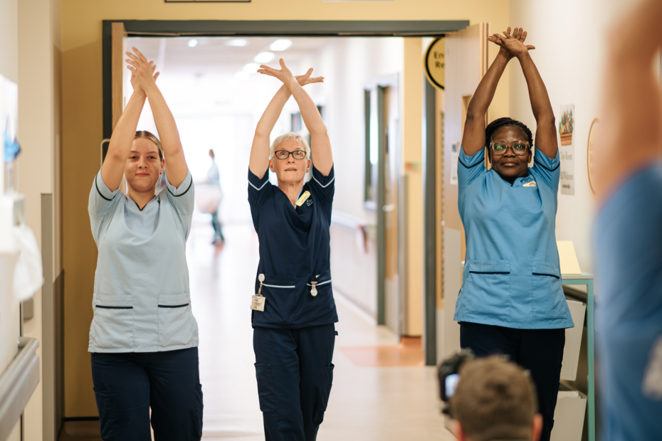 NHSGGC dance in a corridor at the QEUH during movement and dance sessions in April. From left - HCSW Roslyn Dalby, SCN Jane Rafferty, SN Mercy Oppong. Image
