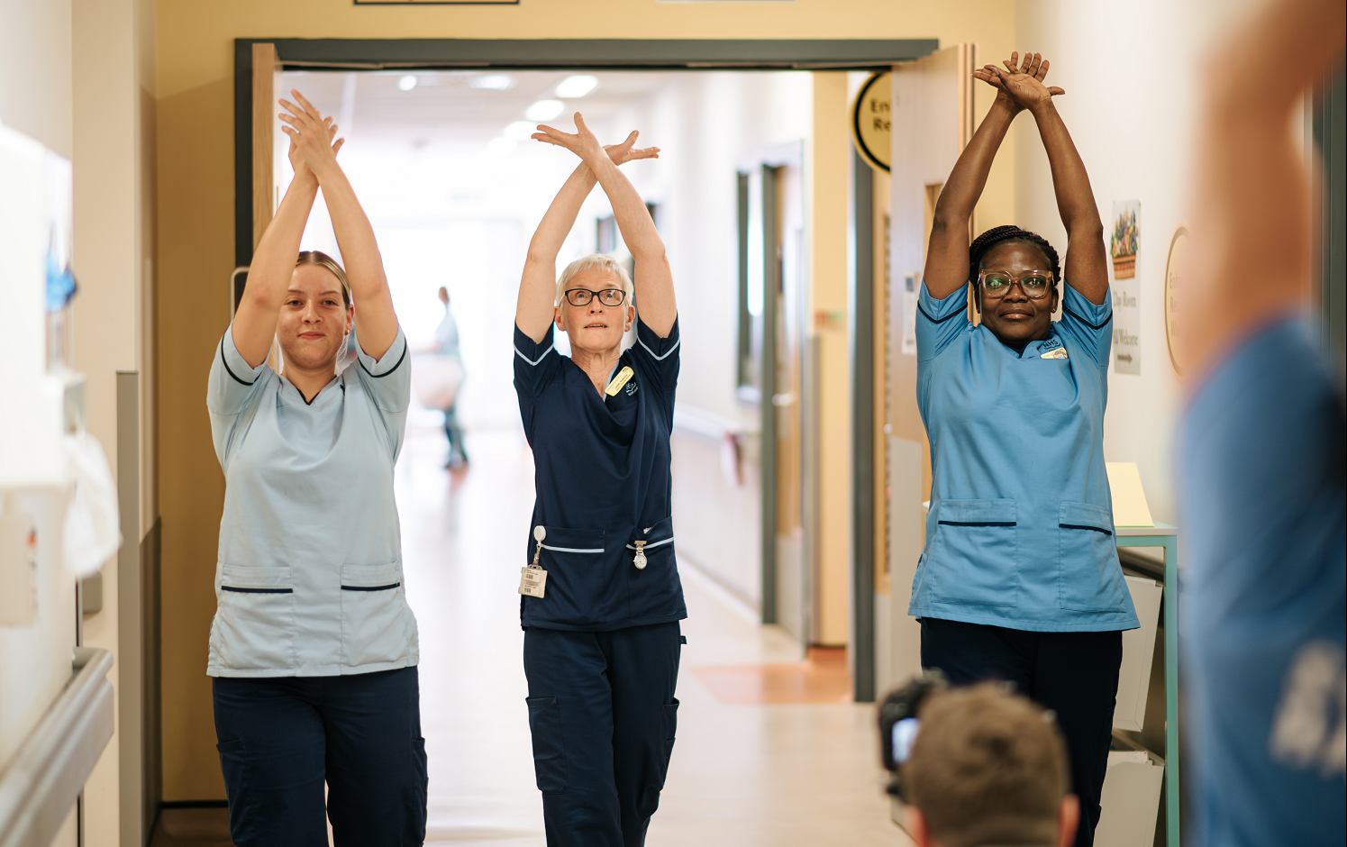 NHSGGC dance in a corridor at the QEUH during movement and dance sessions in April. From left - HCSW Roslyn Dalby, SCN Jane Rafferty, SN Mercy Oppong. Image