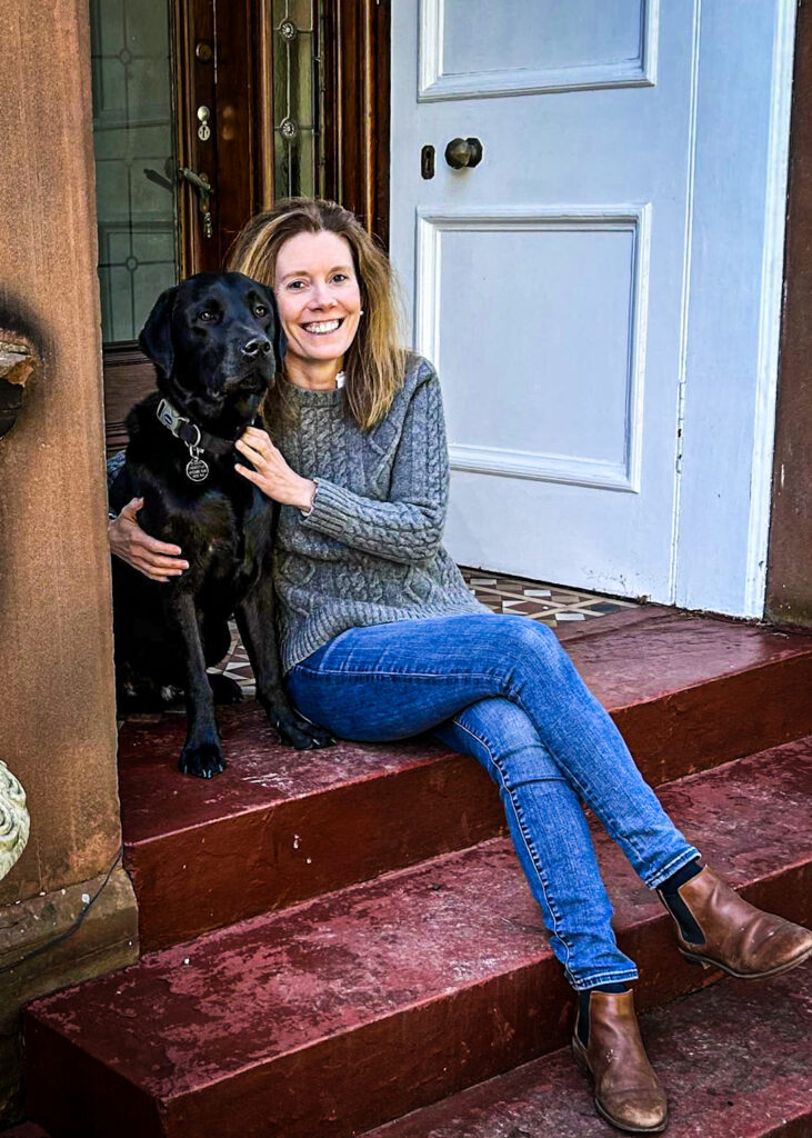 Cooper and owner Dr Helen Grote, sitting on the front step of their Glasgow home.