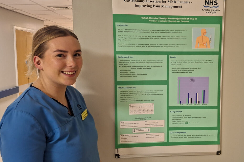 Staff nurse Hayleigh Bloomfield stands beside her award-winning poster