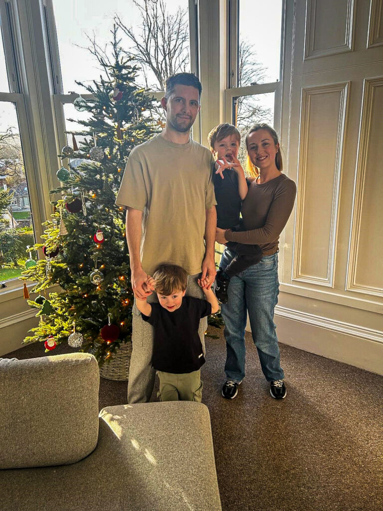 Scott and his family standing in front of their Christmas trees at their Paisley home.