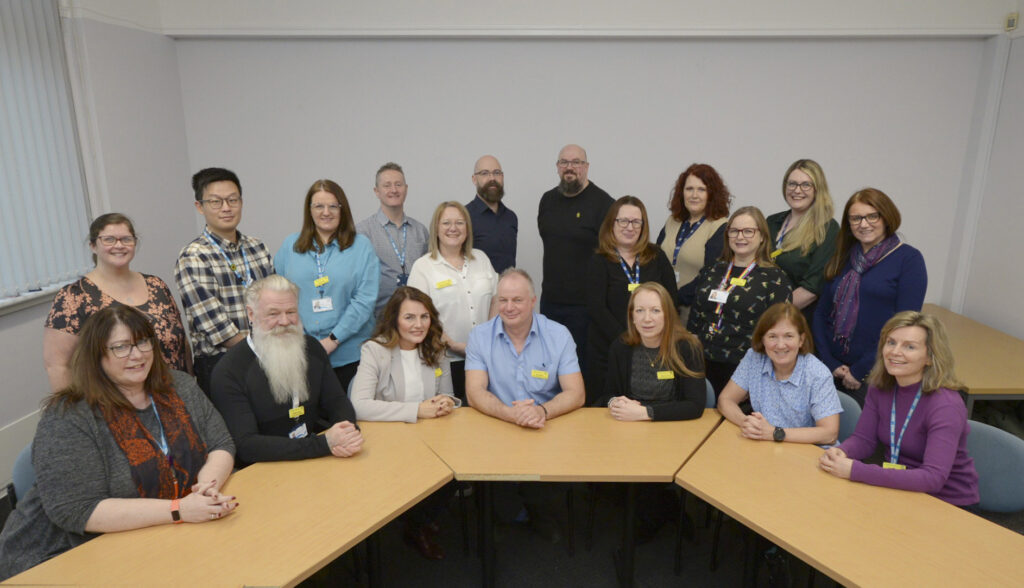 Photograph of NHSGGC Practice Education Team, located in West House GRI, comprising Practice Education Facilitators, Care Home Education Facilitators, and our administration colleague.