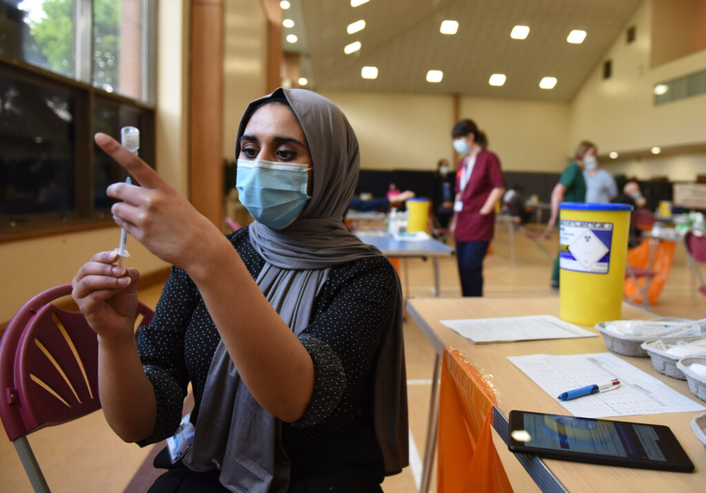 Samiyah Sheikh (Optometrist) administers vaccines at a newly opened surge vaccination centre at Glasgow Central Mosque, Scotland, where people from specific post codes in the South side of Glasgow, are being encouraged to take up the jab to deal with a surge in numbers in Pollokshields and Battlefield. May 18, 2021.